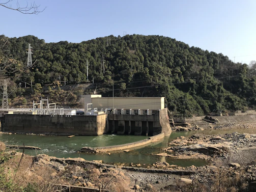 Close-up of water flowing through a hydroelectric dam’s turbines, capturing energy.