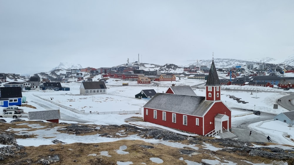 a small red church on a snowy hill