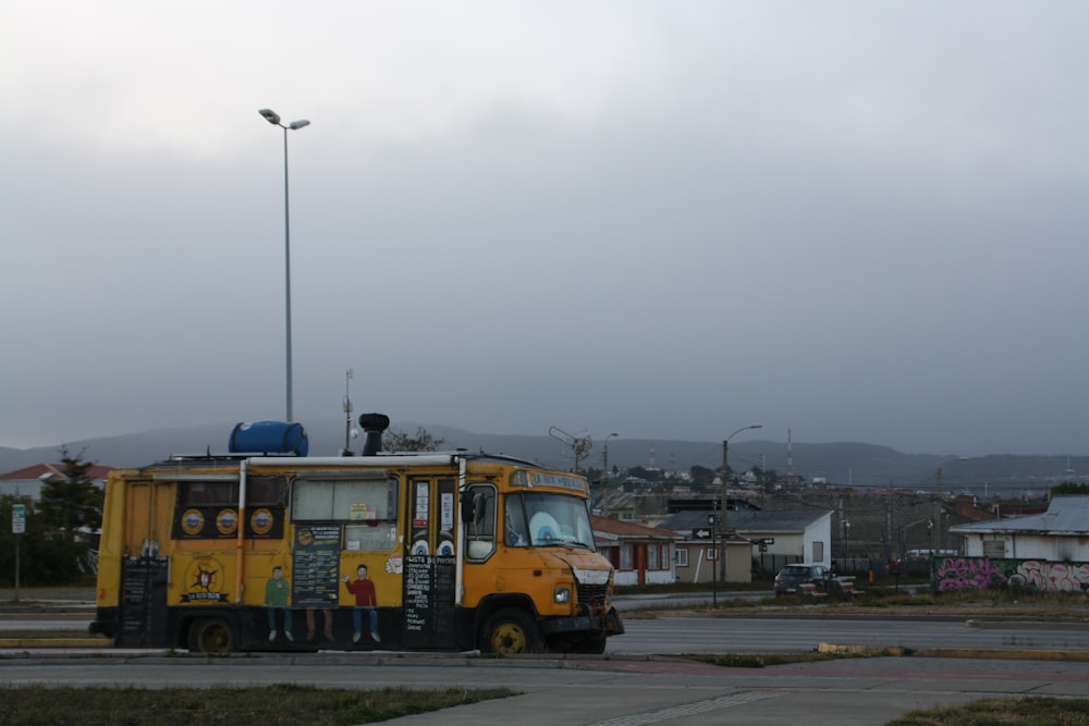 a yellow truck parked on the side of a road