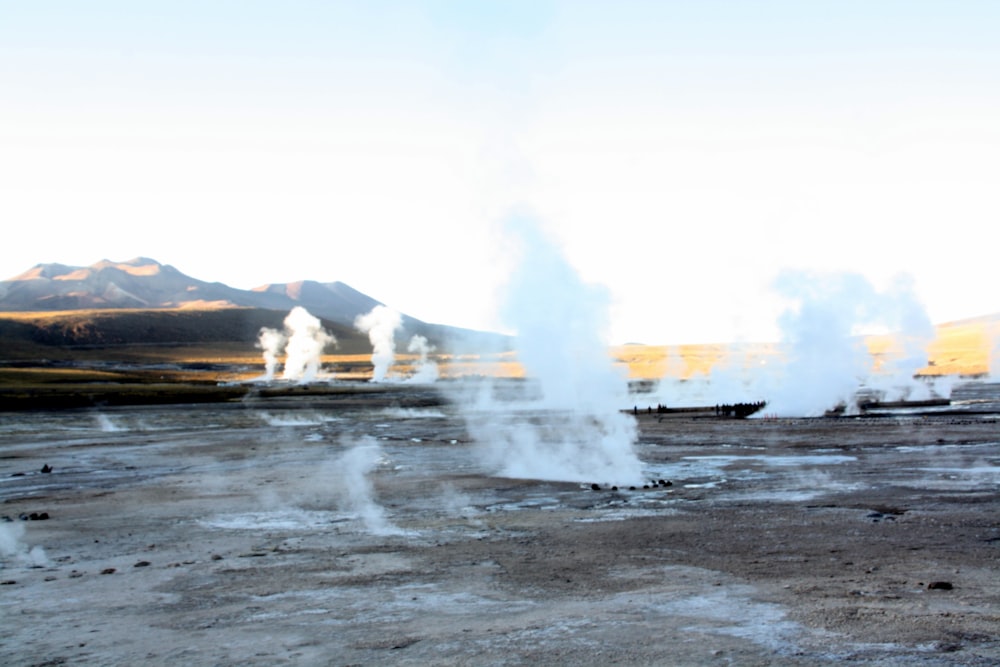 a group of geysers spewing out of the ground