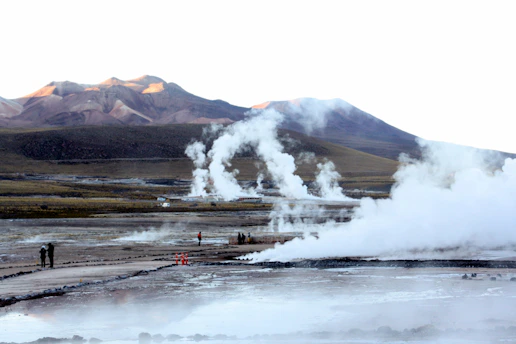 A breathtaking view of Yellowstone's steaming geysers at sunrise.