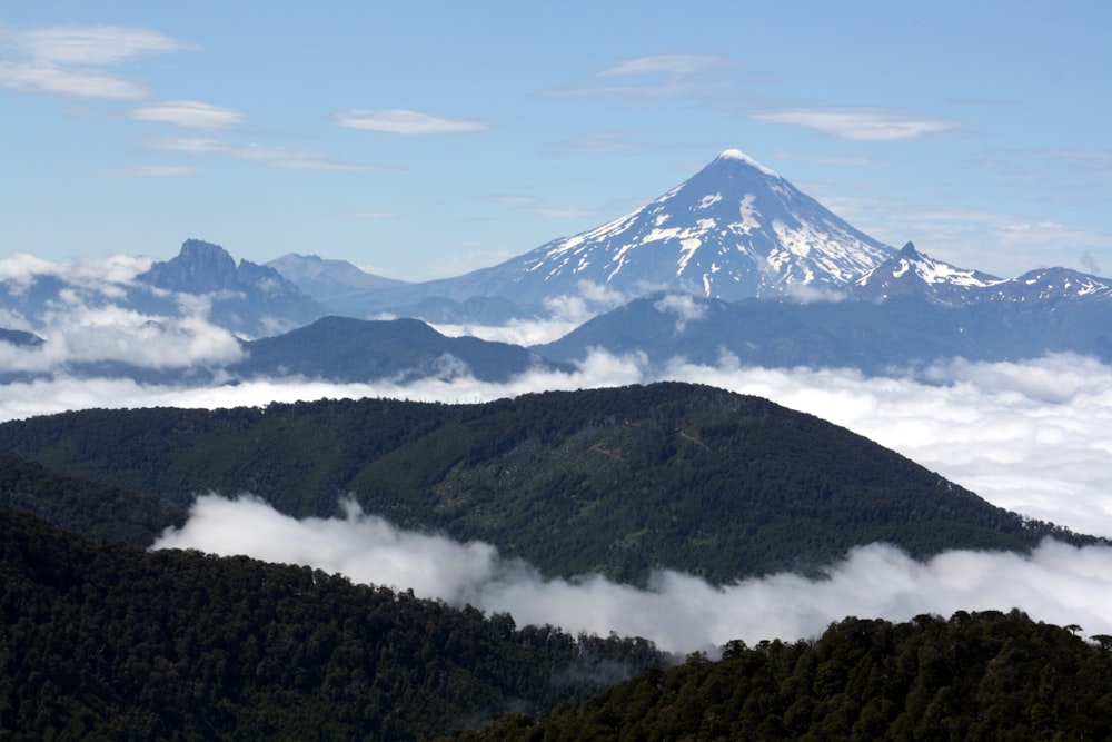 a view of a mountain range covered in clouds