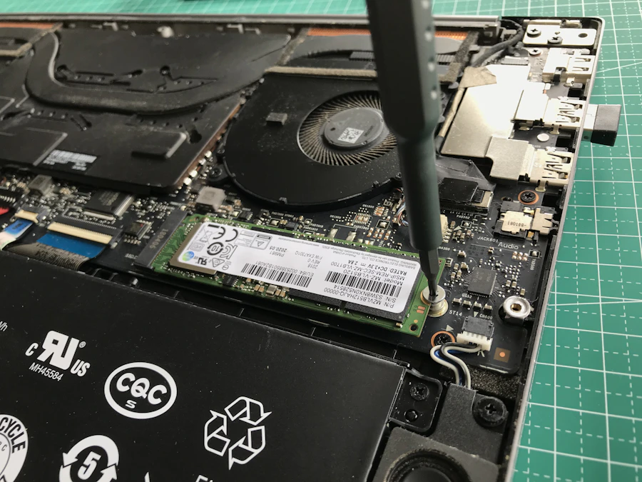 Technician working inside a laptop