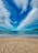 A scenic view of Pensacola Beach with soft white sand and clear blue waters under a bright sky.