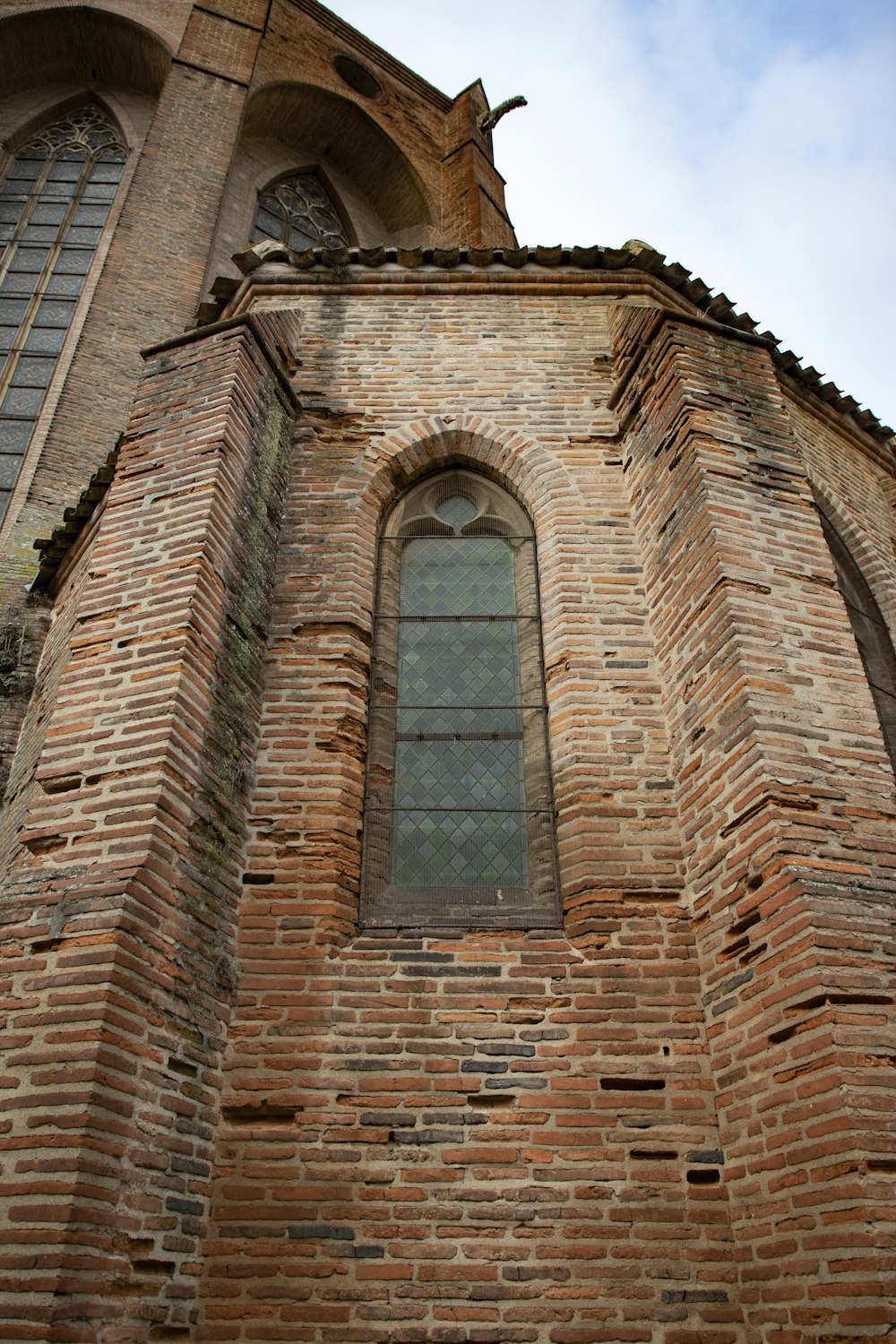 a very tall brick building with a very big window