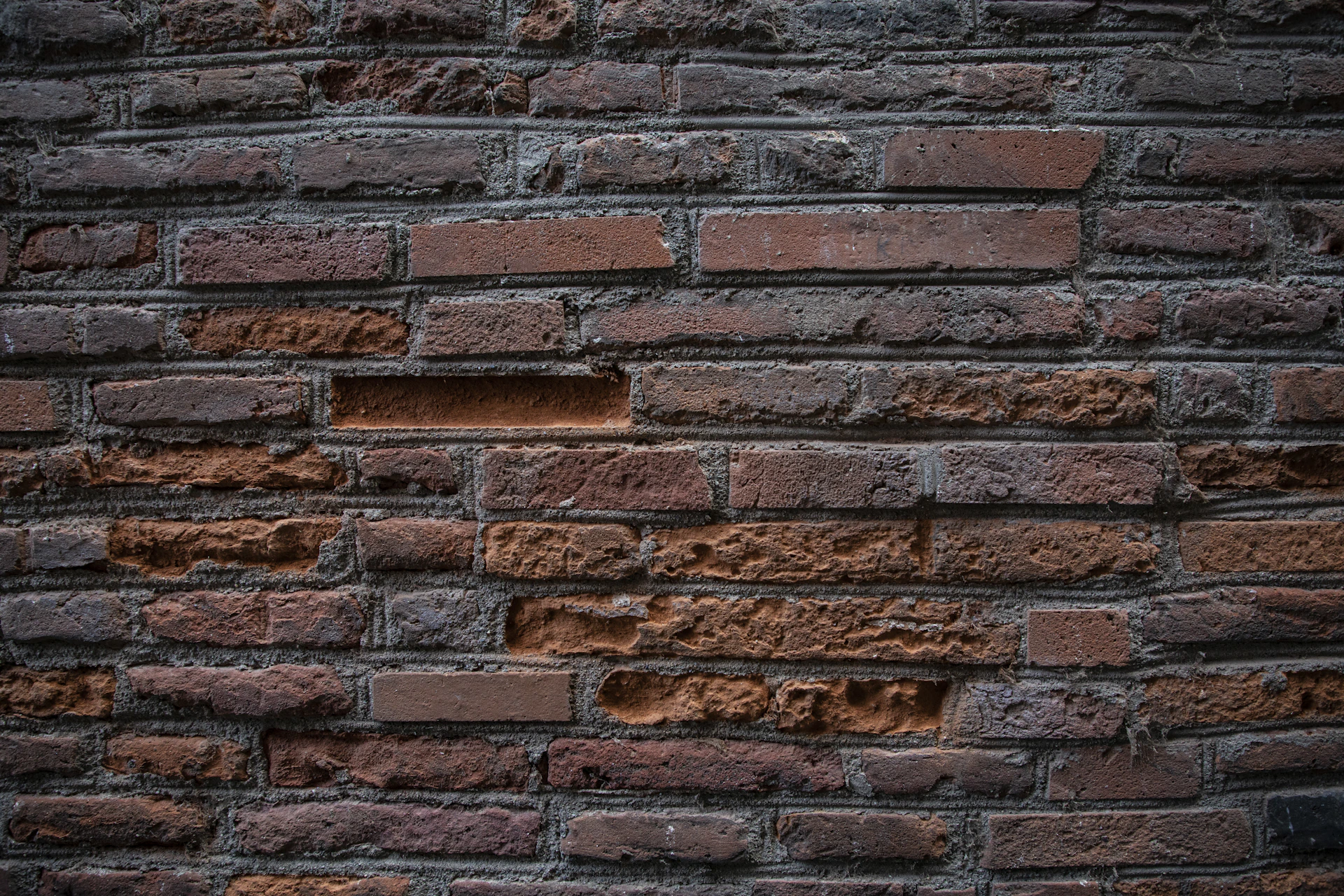 a brick wall with a hole in the middle of it