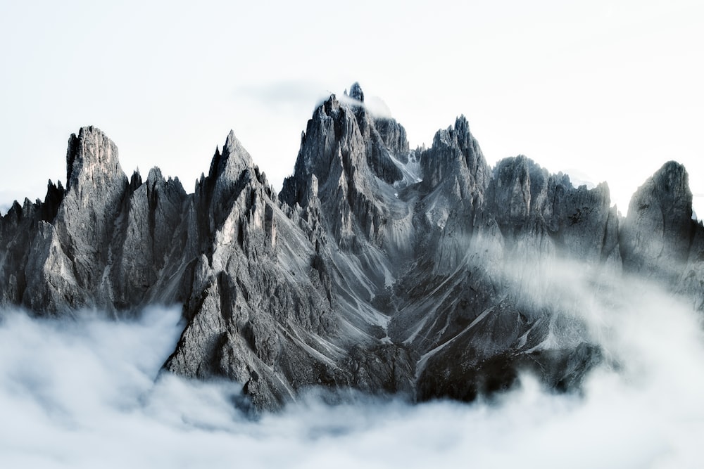 a mountain range covered in snow and clouds