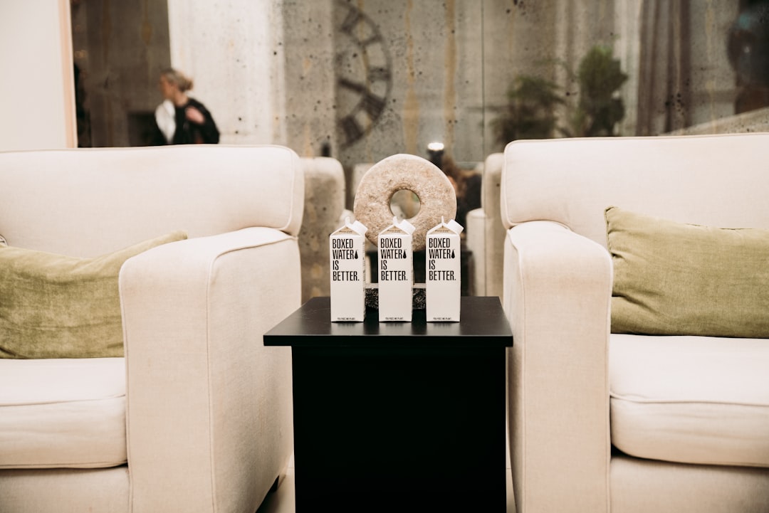 a couple of white couches sitting next to each other,