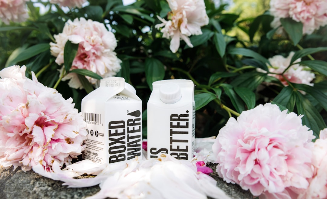 a couple of bottles that are next to some flowers,