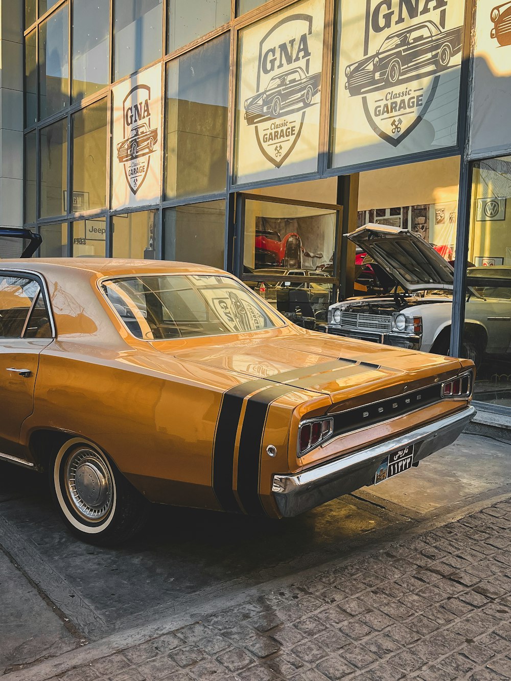 an orange car parked in front of a building