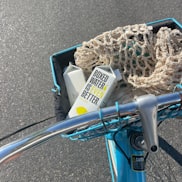 a blue bicycle with a basket full of items