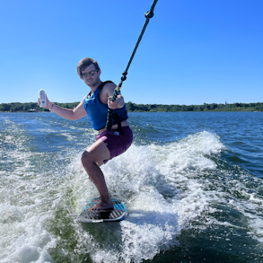 a person riding a board on a body of water