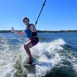 a person riding a board on a body of water