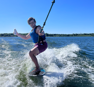 a person riding a board on a body of water