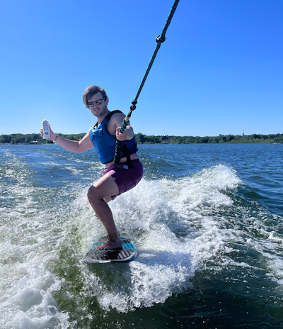 a person riding a board on a body of water