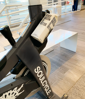 a stationary stationary bike in a building with people in the background