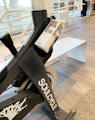 a stationary stationary bike in a building with people in the background