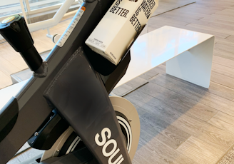 a stationary stationary bike in a building with people in the background