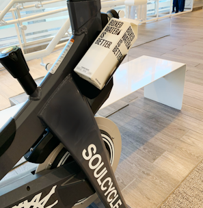 a stationary stationary bike in a building with people in the background