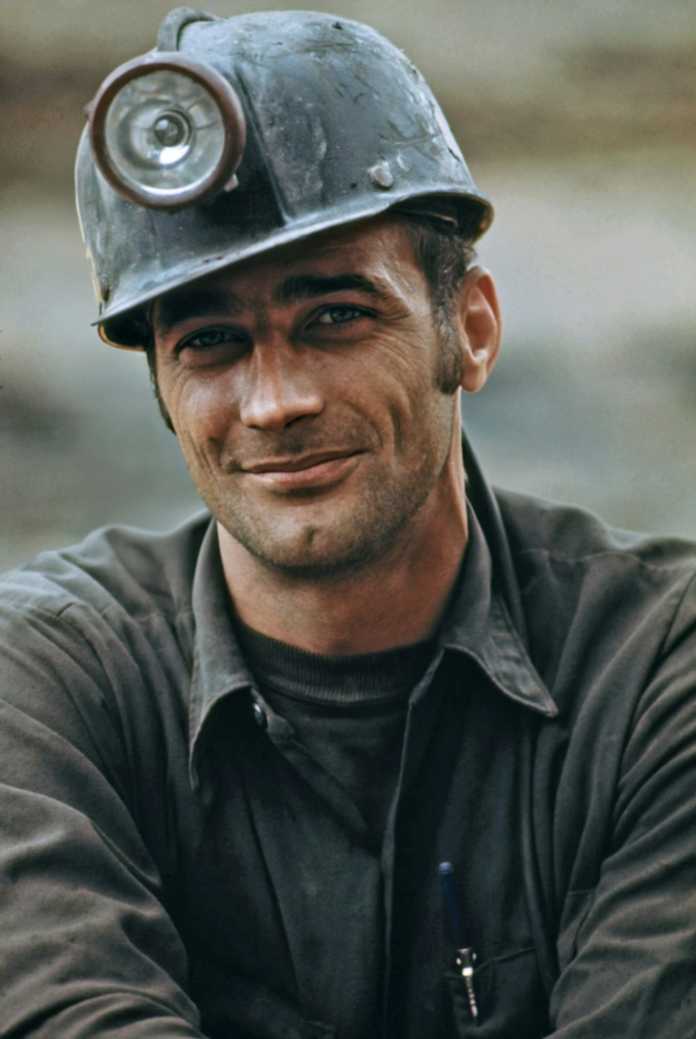 a man wearing a hard hat with a smile on his face