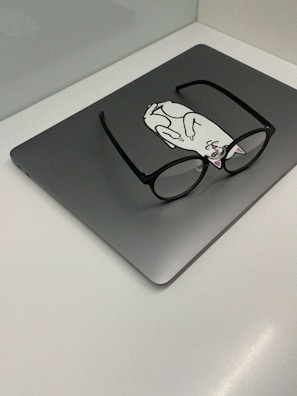 A gadget that folds laundry with a sarcastic cartoon sticker on it.