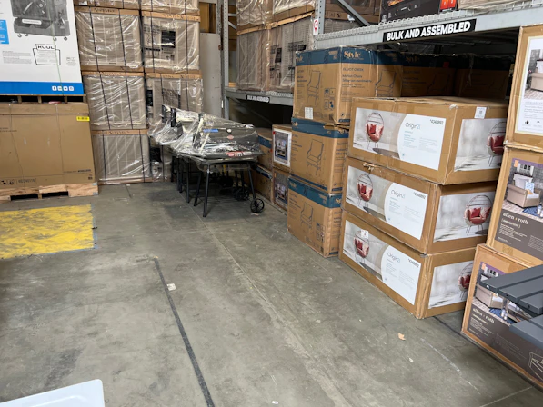 A warehouse filled with neatly stacked appliance stands ready for shipment.