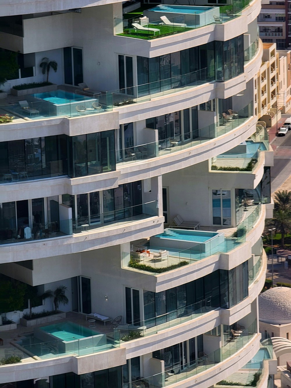 a very tall building with balconies and a swimming pool