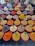 An array of colorful spices and herbs displayed in large red-lipped bowls. Each bowl contains a different spice, with labels such as paprika, nutmeg, cumin, and ginger. The spices are neatly arranged, creating a vibrant and diverse tapestry of textures and colors.