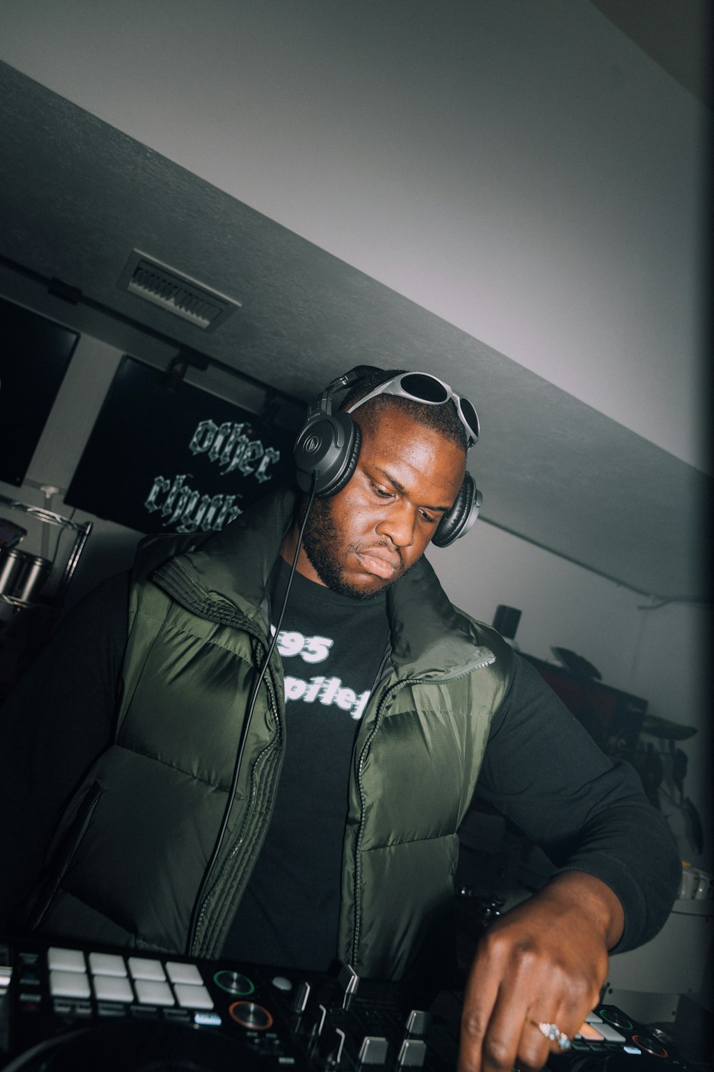 a man in headphones mixing music in a room