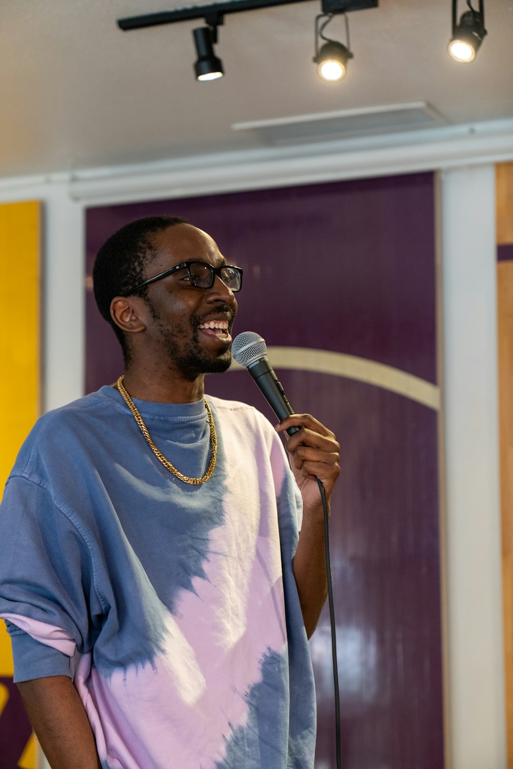 a man standing in front of a microphone