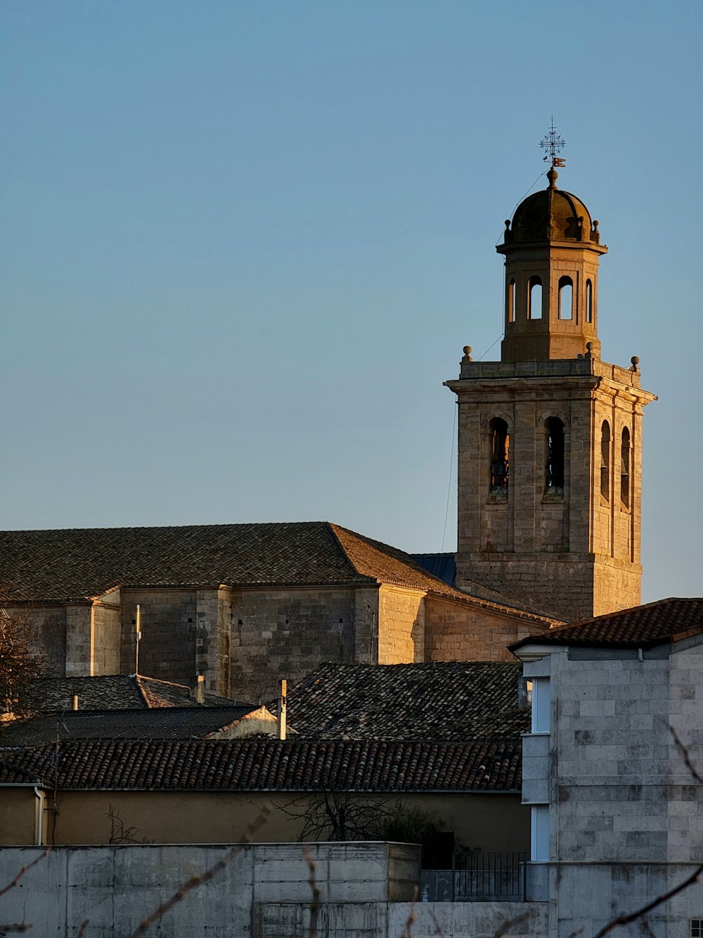 a church steeple with a clock tower in the background