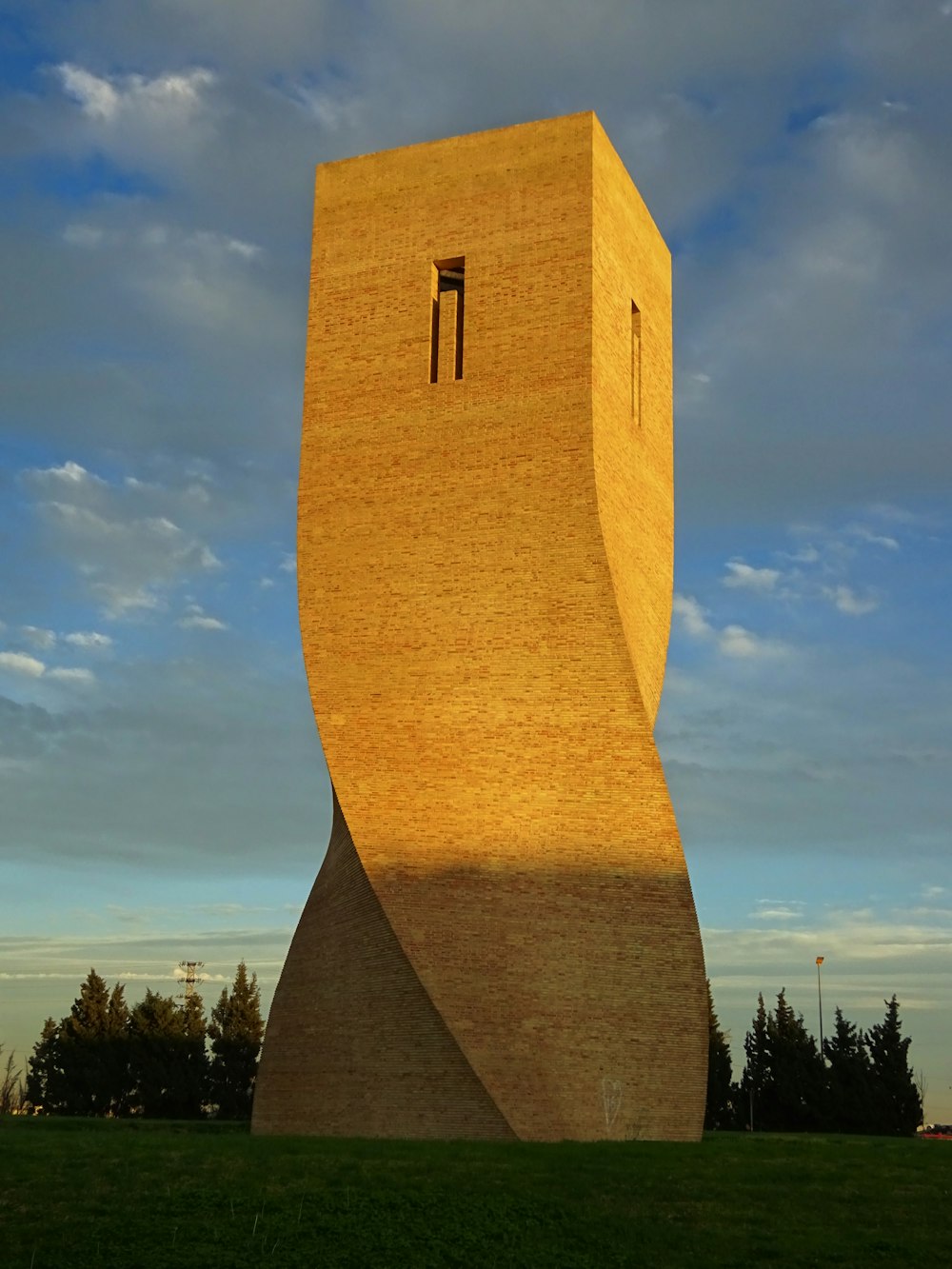 a tall building with a small window on the side of it