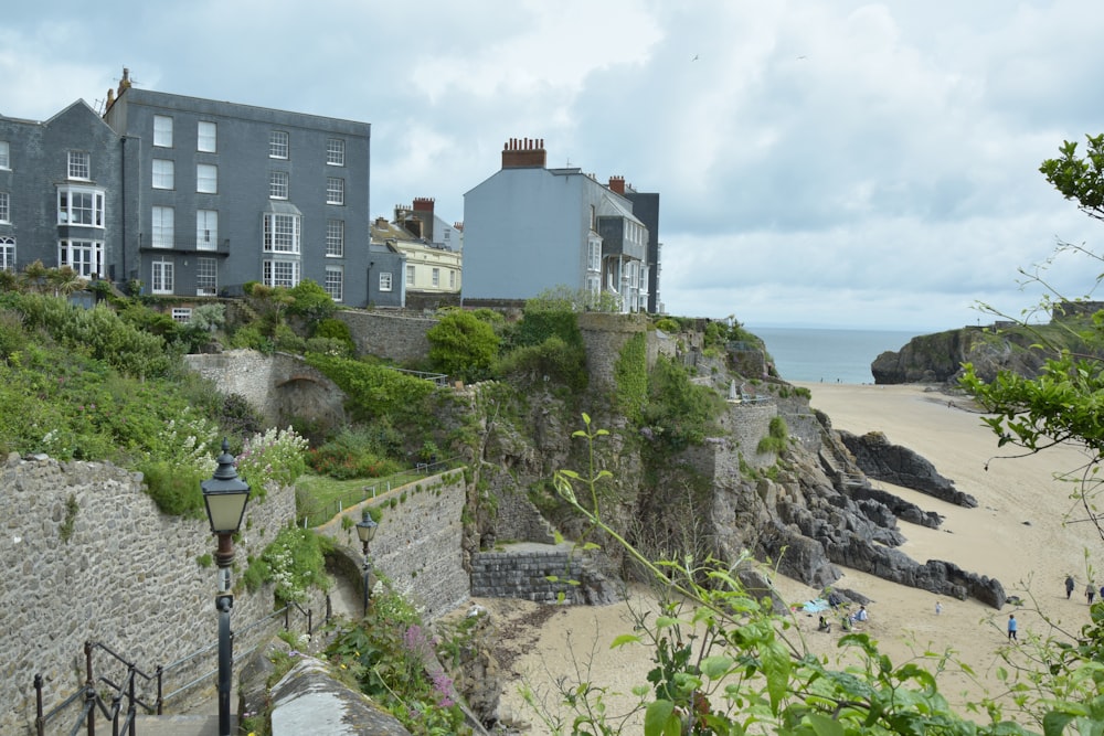 a group of houses on a cliff overlooking the beach