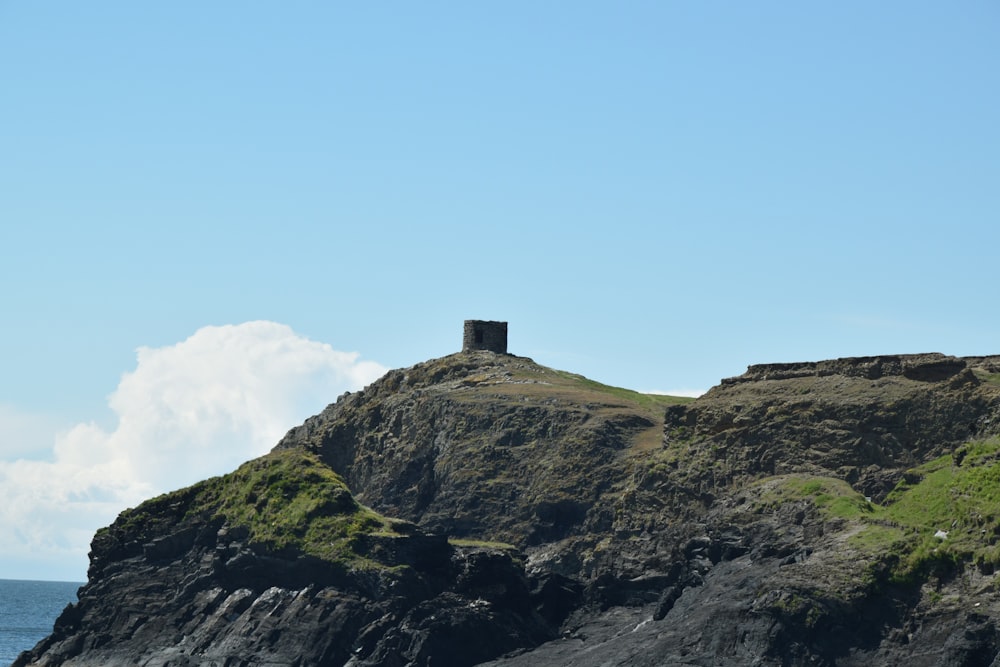 a rock outcropping with a tower on top of it