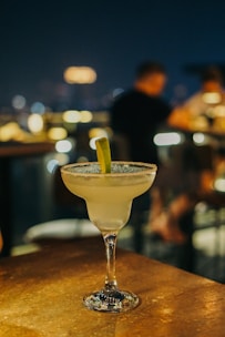 A refreshing margarita glass rimmed with salt, garnished with a lime wedge.