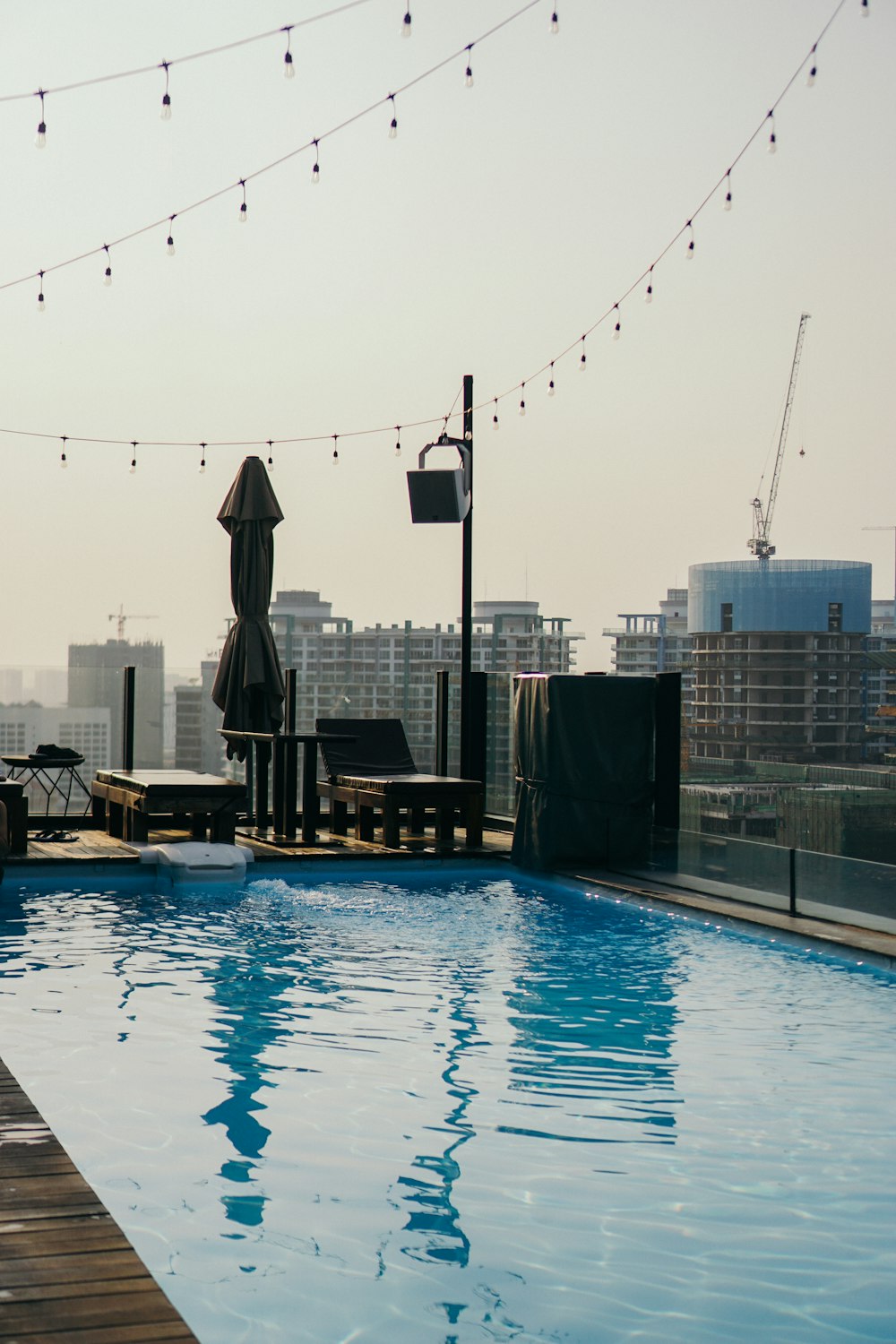 a large swimming pool with chairs and umbrellas