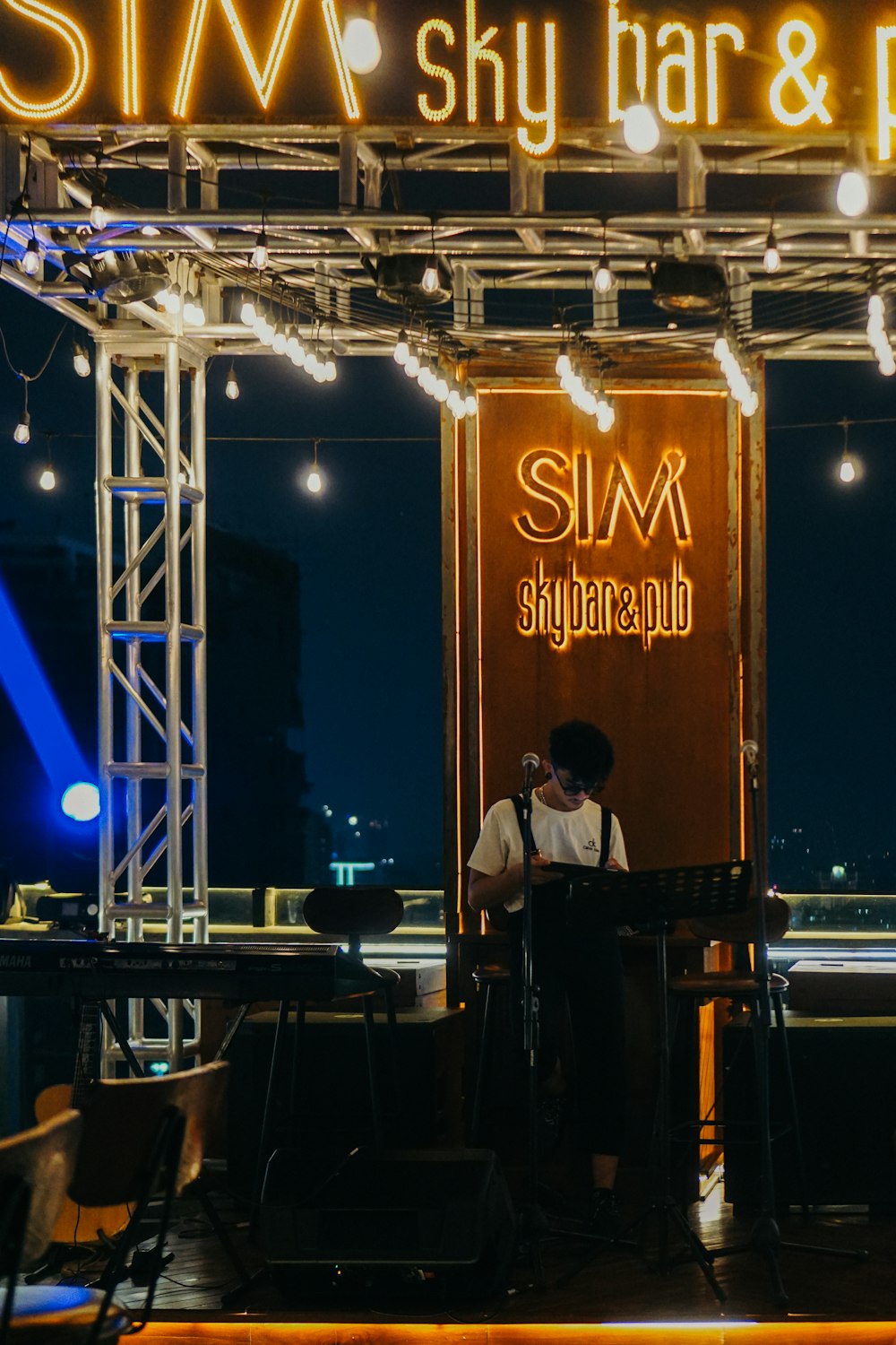 a man standing in front of a stage at night