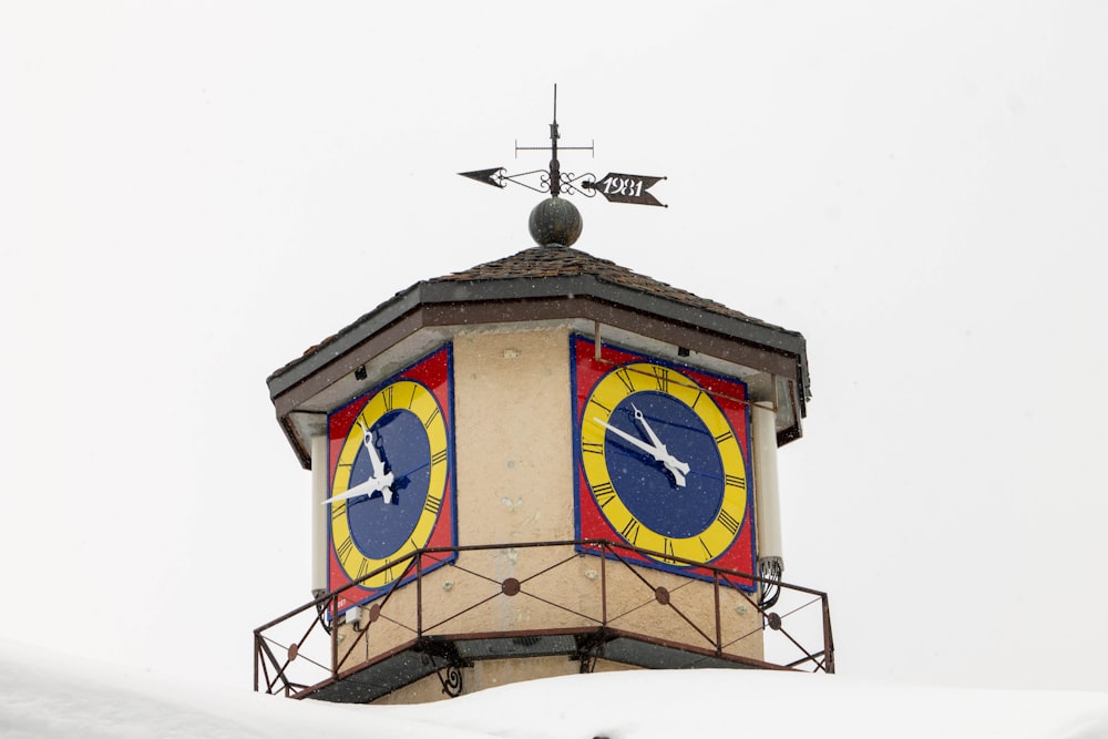 a clock tower with a weather vane on top of it