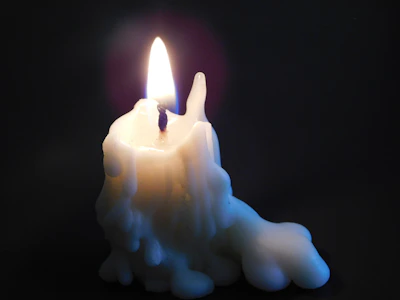A candle jar with melted wax pooling evenly across the surface.