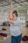 Solo yoga session in a large meditation hall in Rishikesh, surrounded by peaceful ambiance