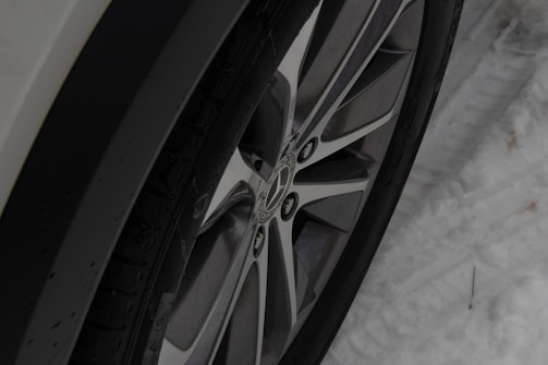 Seasonal tire changeover with winter tires being installed on a vehicle.