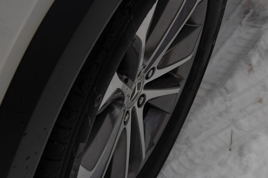 A split image showing summer tires on one side and winter tires on the other.