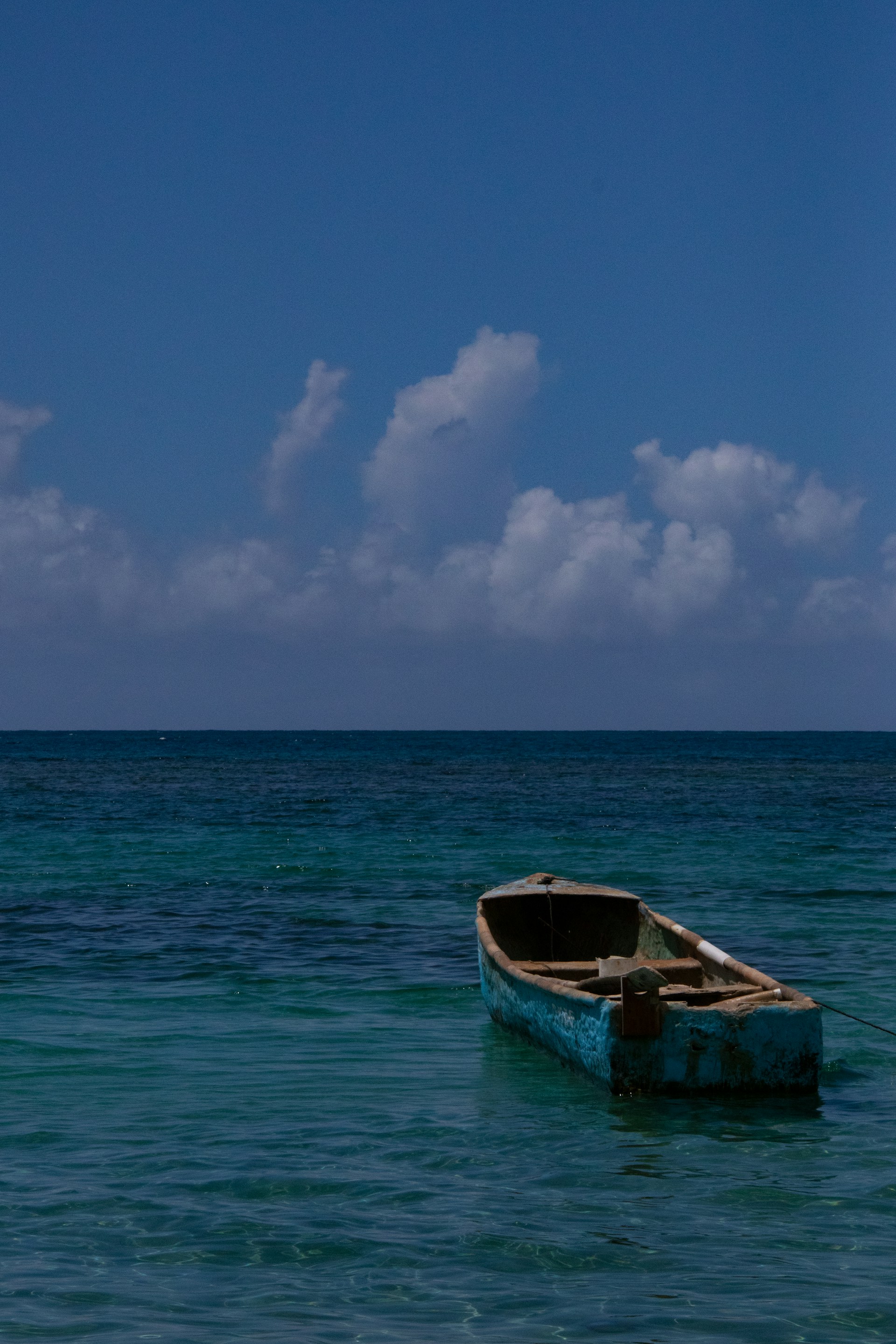 a small boat floating on top of a body of water