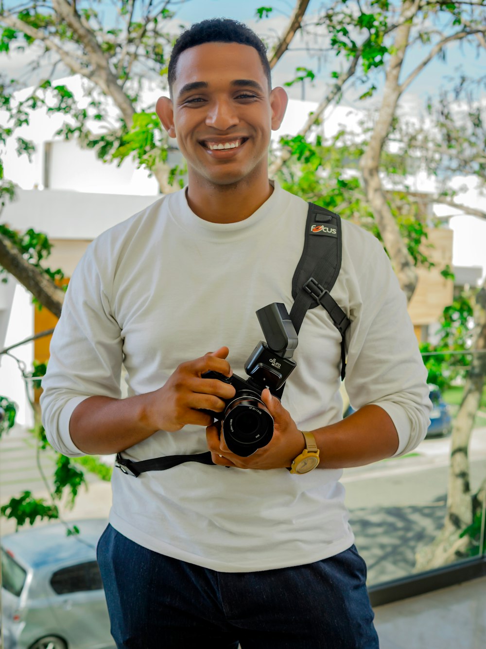a man is holding a camera and smiling