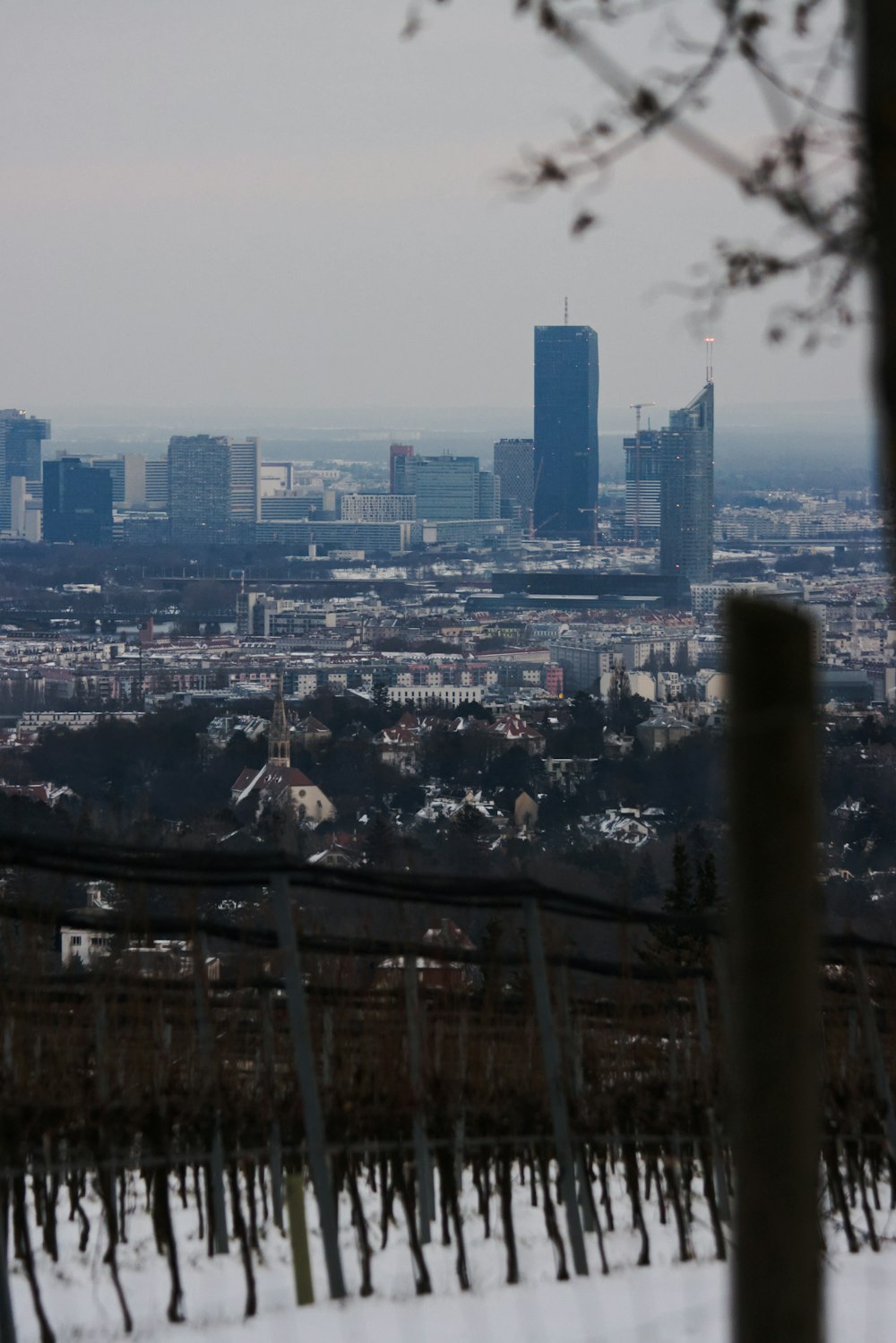 a view of a city from a snowy hill