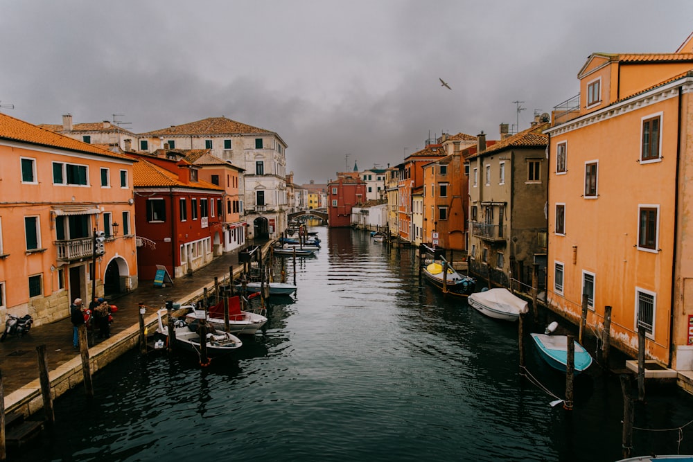 a waterway with several boats and buildings on both sides