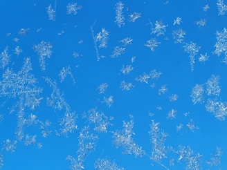 Snowflake motifs subtly falling around a professional HVAC system installation.
