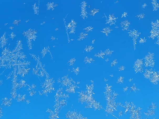 Snowflake motifs subtly falling around a professional HVAC system installation.