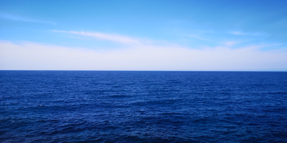 a large body of water with a sky background