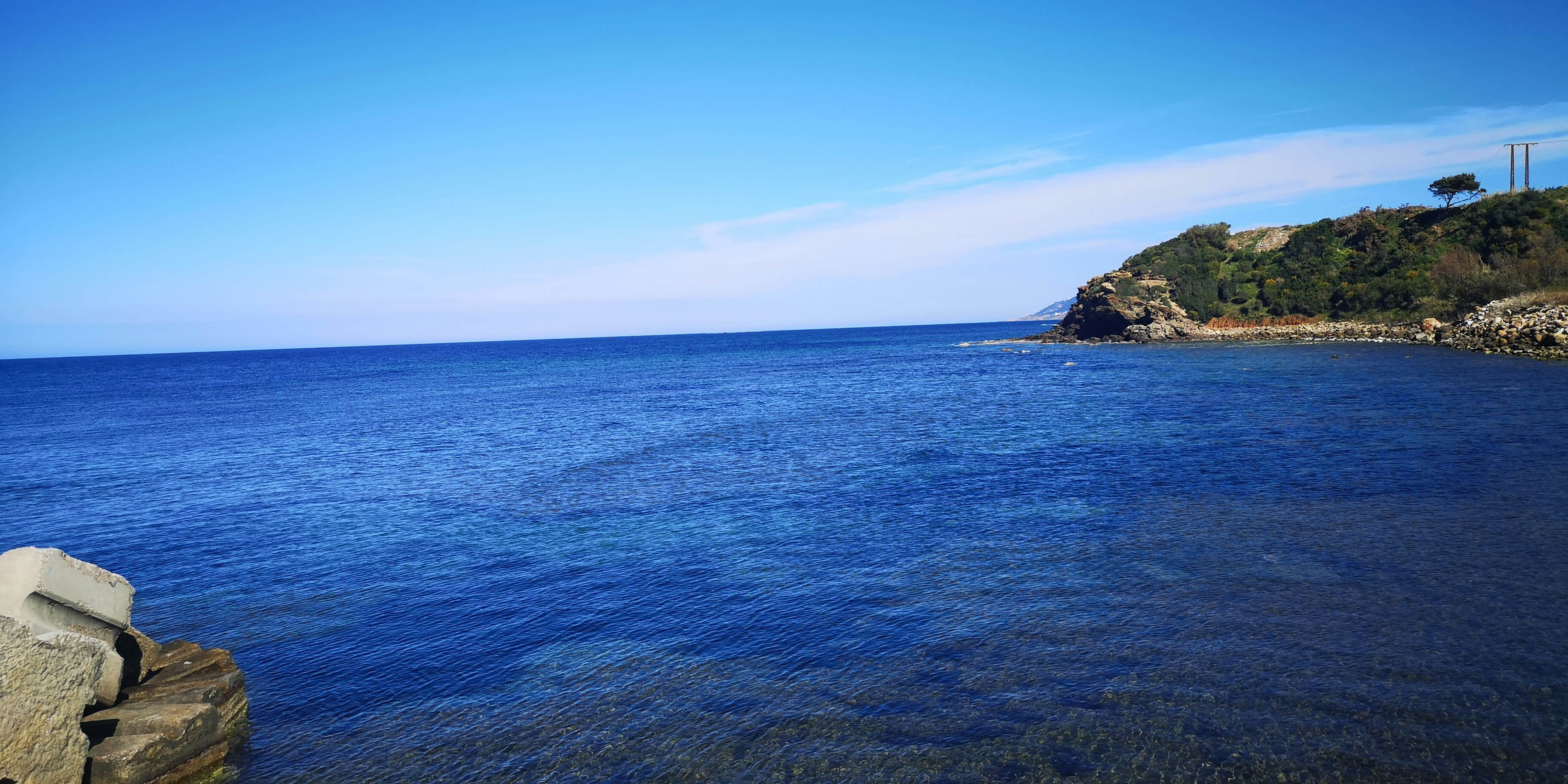 a body of water with a small island in the background